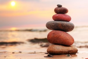 Stones pyramid on sand symbolizing zen, harmony, balance.