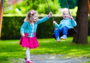 Kids on playground swing